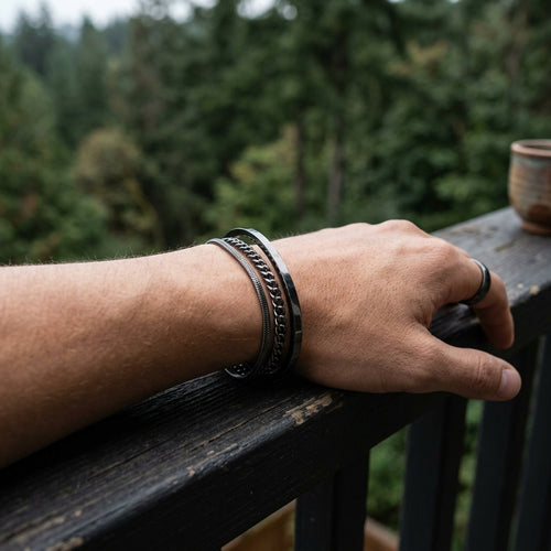 Bracelets stacked on wrist on railing outdoors